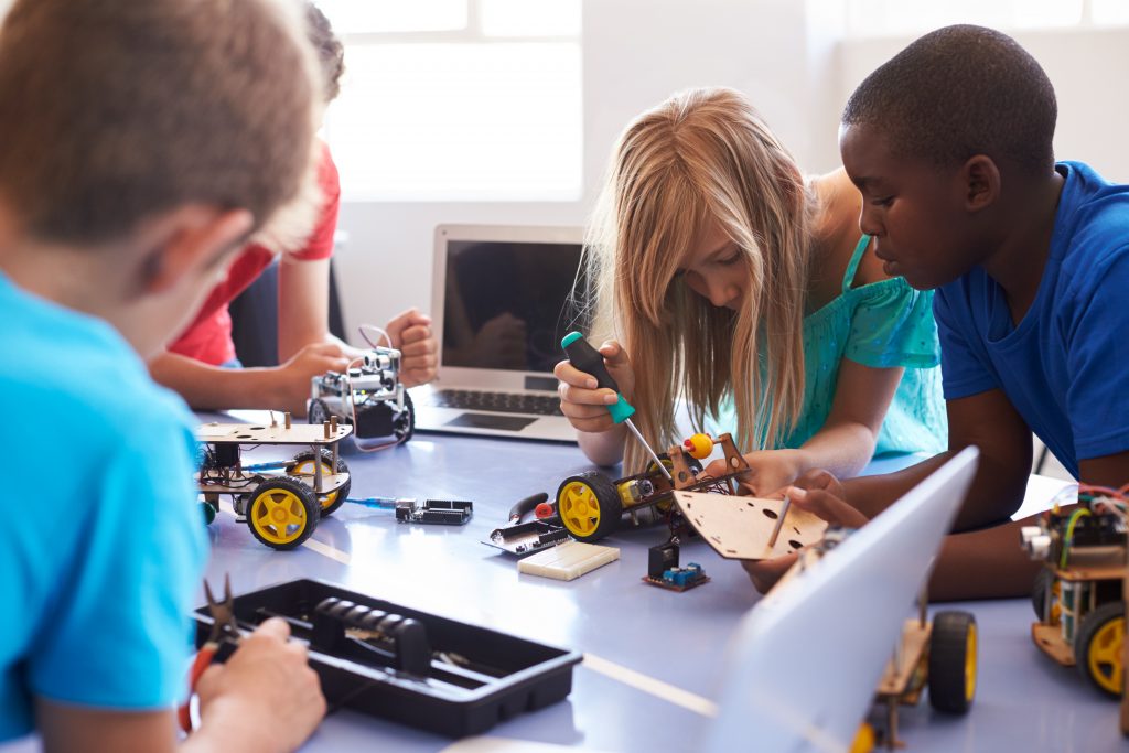 Students learning about coding and building in school Student after school computer coding class