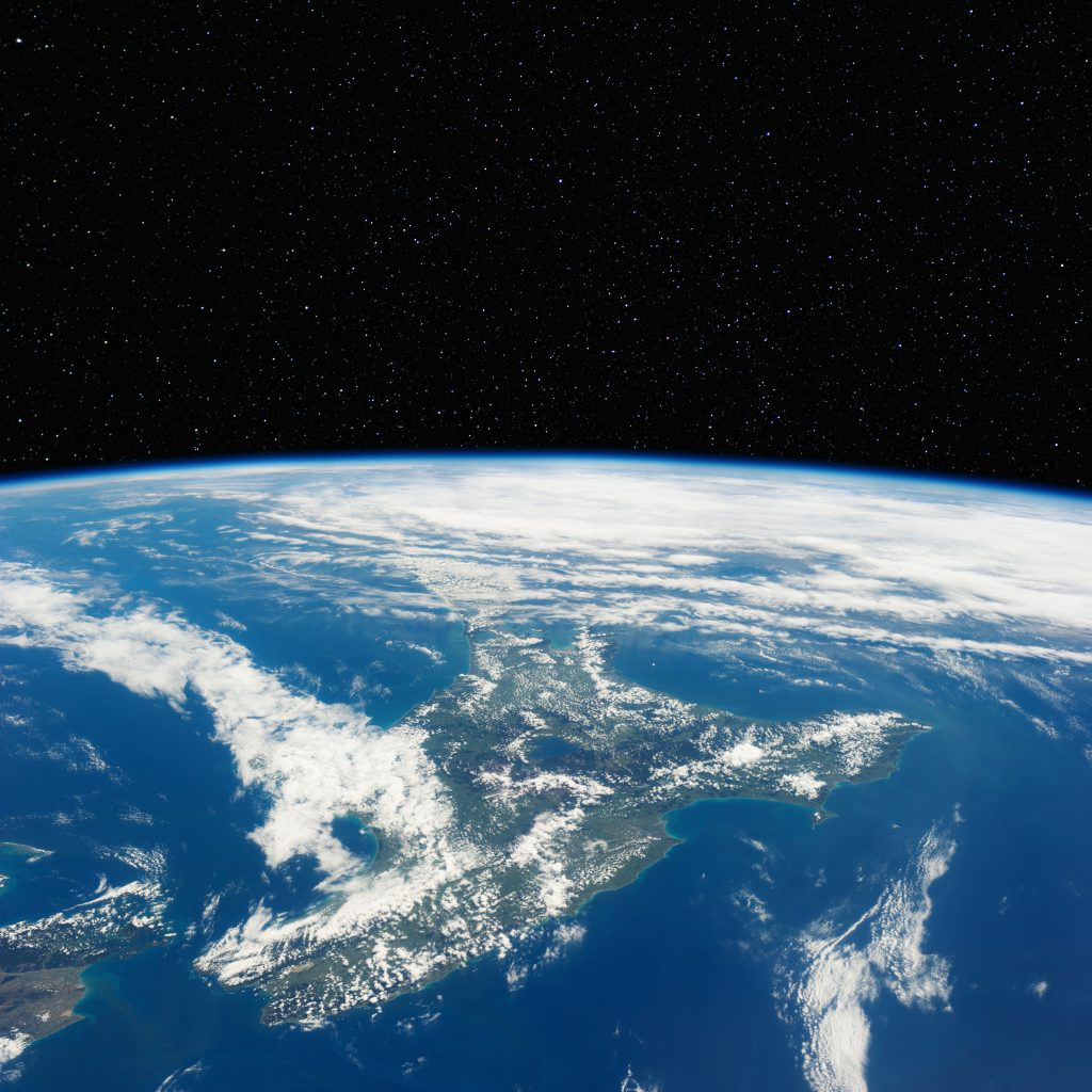 A black space background with Earth as seen from space in the bottom half.